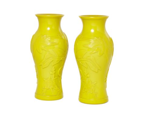 A pair of Chinese carved yellow 'Peking' glass baluster vases20th centuryEach boldly carved in mirror image around the body w