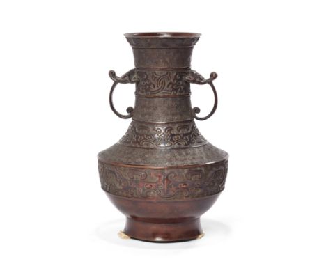A Japanese bronze archaistic baluster vaseMeiji periodCast with alternating borders of taotie and spiral motifs, the slender 