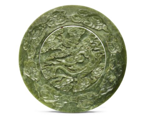 A large Chinese spinach jade 'dragon' circular plaque20th centuryThe central medallion rotating within a circular frame and a