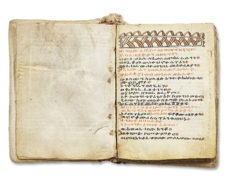 An Amharic manuscript,Northeast Africa, 19th Century,Black and red ink text on vellum, opening folio with red and black swirl