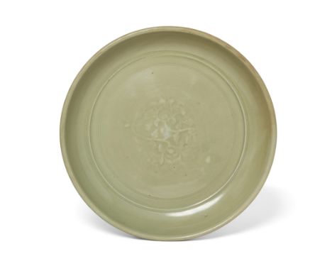 A Chinese Longquan moulded celadon-glazed dishEarly Ming dynasty, 14th/15th centuryThe plain form thickly potted with a mould