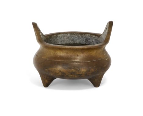 A Chinese bronze bombé-form tripod incense burnerLate Qing dynasty, apocryphal Xuande markStanding on three conical feet, the