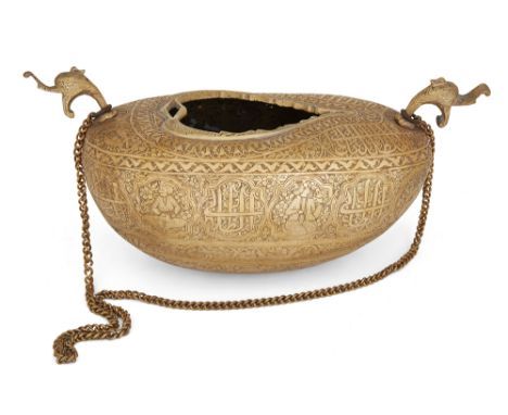 A Qajar engraved brass kashkul, Persia, 19th century, of typical coco-de-mer form, the ends rising to two pronounced dragon-h
