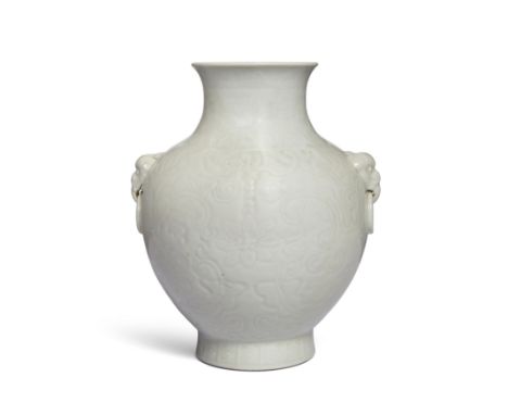 A Chinese white-glazed carved 'bats and flowers' vase, huRepublic period, apocryphal Qianlong seal markThe globular body deli