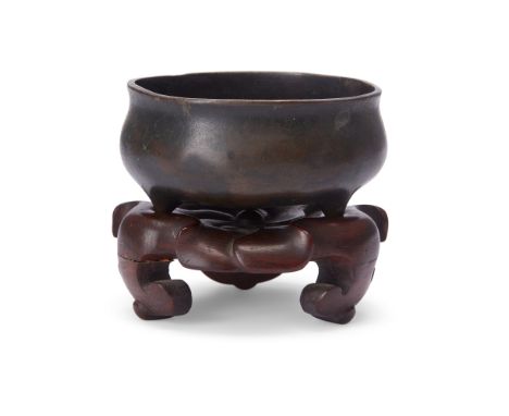 A small Chinese bronze tripod incense burnerMing dynasty, 17th/18th centuryOf typical bombé form, apocryphal Xuande six-chara