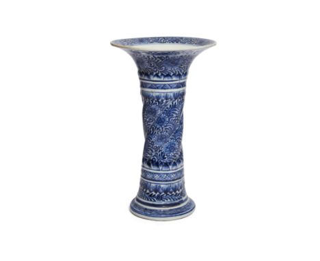 A Chinese blue and white fluted 'floral' beaker vase, guQing dynasty, Kangxi periodRising from splayed foot to flared rim, th