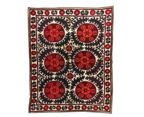 A large medallion-type Susani, Samarkand, Uzbekistan, early 20th century, in red, black and cream cotton, with hanging attach