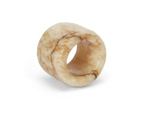 A Chinese 'chicken bone' jade thumb ringQing dynasty, 17th/18th centuryCarved from a creamy-white stone with streaky russet i