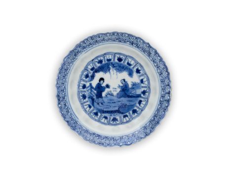 A small Chinese blue and white 'scholar and beauty' moulded barbed-rimmed dishQing dynasty, Kangxi periodPainted to the centr
