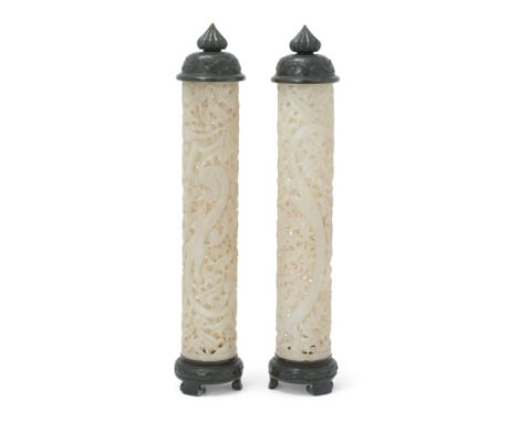 A pair of Chinese white jade cylindrical 'dragon and lotus' parfumiers with spinach jade stands and covers20th centuryPierced