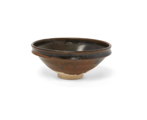 A Chinese Henan black-glazed bowlYuan dynastyThe tall conical sides terminating in a lipped rim, covered in a black glaze wit