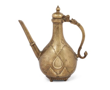 A Mughal moulded brass ewer, India, early 19th century, pyriform, on four short cylindrical feet, engraved with hanging and r