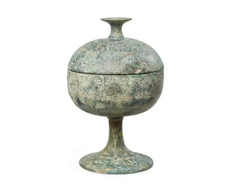 A Chinese archaic bronze ritual vessel and cover, douHan dynastyThe globular vessel and cover standing on a tall, slender, sp