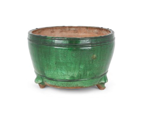 A Chinese northern kiln green-glazed stoneware incense burnerYuan - Ming dynastyThe heavily potted vessel raised on tripod fe