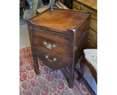 A George III Mahogany Nightstand with a low galleried top above a pull out commode with brass swan neck handles raised upon s