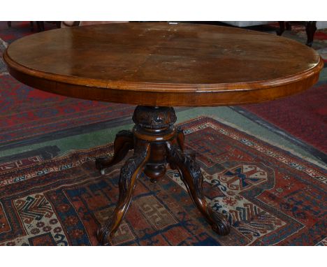 A Victorian burr walnut oval breakfast table, moulded quarter veneered top, turned pillar and cabriole legs carved with acant