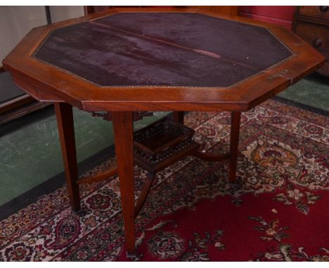 A Victorian oak and mahogany octagonal card table, folding top enclosing a tooled and gilt leather playing surface, basket un