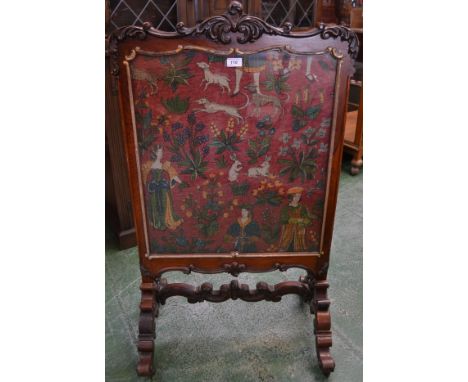A rosewood framed tapestry fire surround, scrolled and carved top rail, gilt relief moulding around glazed panel, enclosing t
