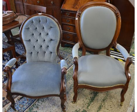 A Victorian mahogany salon armchair, with oval back, upholstered pale blue, raised on slender curved front legs and casters; 