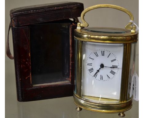 A late 19th century French lacquered brass oval carriage timepiece, 6cm white enamel dial with Roman numerals, key-wound move