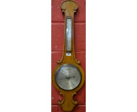 A Victorian oak wheel barometer, 19cm silvered register inscribed J Davis &amp; Son, London &amp; Derby, mercury thermometer,