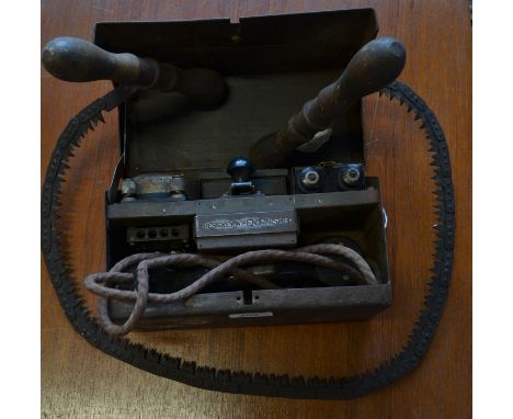 World War Two - a British Army field telephone, D MKV, of typical form, 1939 - 1945; a paratrooper's saw, turned wooden handl