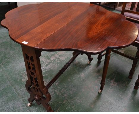 A Victorian rosewood Sutherland table, shaped oval top, pierced end supports, turned stretcher, ceramic casters, 73cm high, 9