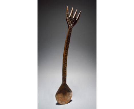 A Nigerian ladle with carved decoration and a prong terminal, 60.5cm long. Provenance The Fowler Museum, UCLA, c. 1988.
