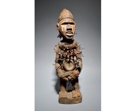A Kongo power figure Democratic Republic of the Congo with nails, cloth, fibre, bone, mirrored glass and feathers, with white