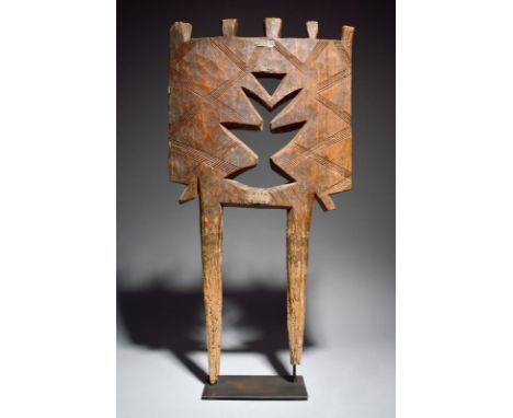 A Tuareg tent post Chad carved a castellated top and a pierced central motif, with incised linear decoration and two tapering