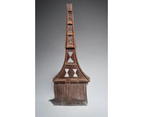 A Fiji large comb Melanesia with a tapering handle pierced hourglass motifs and carved chevrons, the top inscribed BULA, 53cm