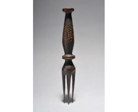 A Fiji cannibal fork Melanesia with four prongs above a double disc knop and a zig-zag carved handle and a disc terminal, 19t