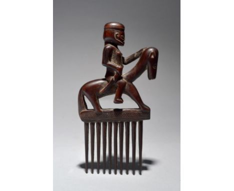 A Songo equestrian figure comb Angola the seated male rider with his left hand on the horse's head and his right clenching a 