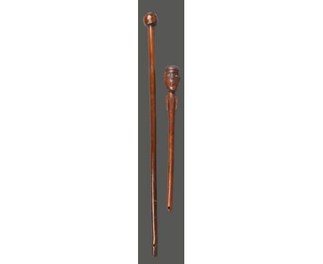 A Zulu knobkerrie South Africa with a faceted head, and the base of the handle pierced for attachment, 75cm long, a South Afr