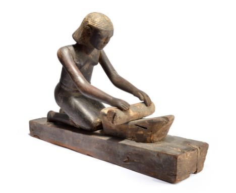 An Egyptian kneeling female figure grinding Middle Kingdom, circa 2000 BC with ribbed hair and wearing a belt, with her hands