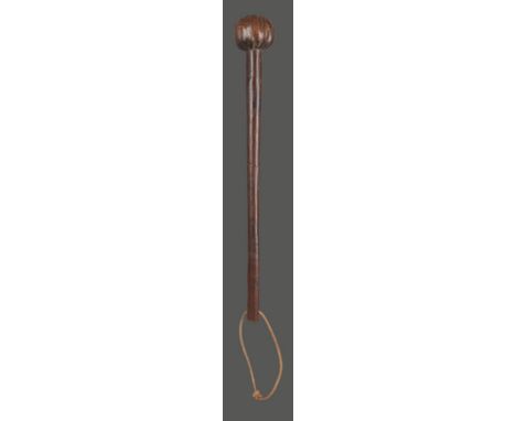 A Zulu knobkerrie South Africa with a fluted spherical head, the end of the handle pierced, 49cm long.