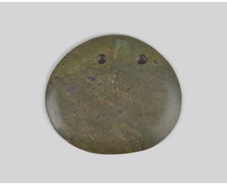 A Kanak ceremonial axe head New Caledonia nephrite, with two holes for attachment, 15.1cm wide.