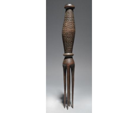 A Fiji large cannibal fork Melanesia with four prongs and a knoped ovoid handle with carved zig-zag decoration, 37cm long.
