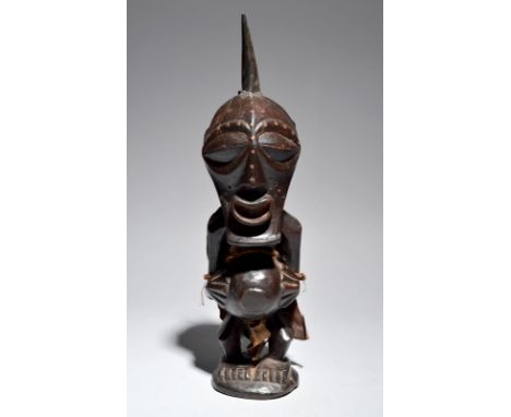 A Songye power figure Democratic Republic of the Congo with a horn charge to the top of the head, the face with copper nails,