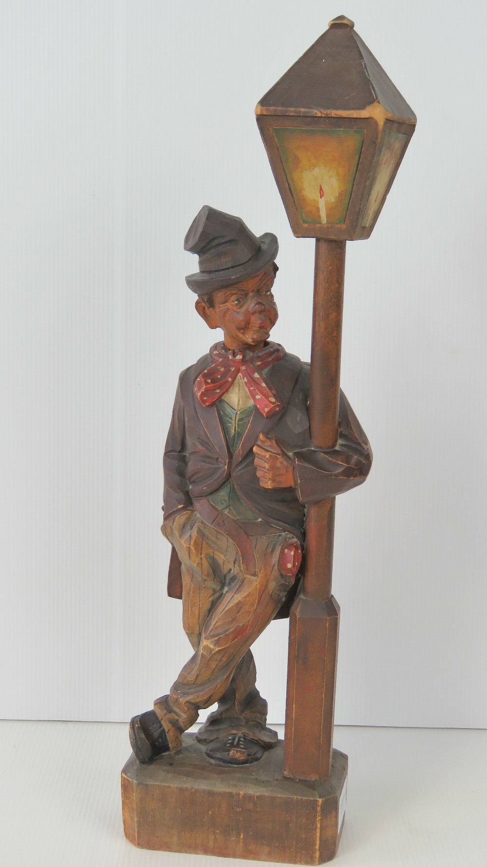 A Black Forest type clockwork novelty automaton figurine, whistling man leaning against lamppost,