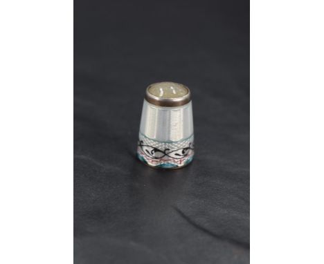 A fine Norwegian enamelled silver and opalescent glass thimble, of traditional form with inset moonstone head over the engine