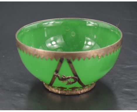 An early 20th century Chinese white metal mounted green glass bowl, of dished circular form with geometric/serrated and styli