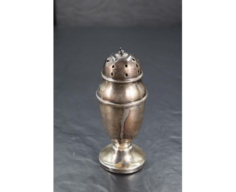 A George V silver sugar caster, of elongated urn form with finial topped and pierced pull-off cover and spreading circular fo