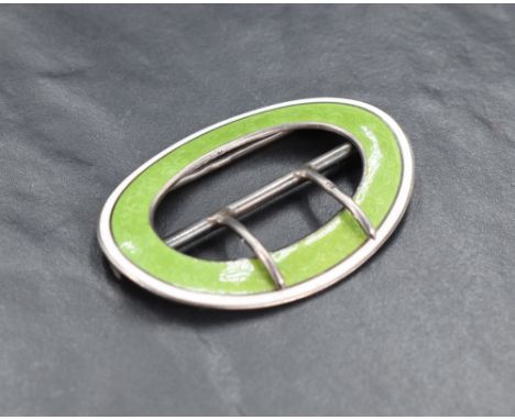 A George V guilloche enamelled silver shoe buckle, of oval form, engine turned with foliate scrolls and enamelled in green wi