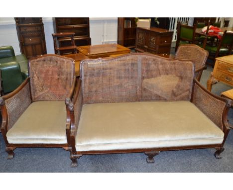 An early 20th century mahogany and  bergere suite,  comprising of two seat sofa and two armchairs, lion mask arm terminals, p