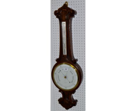 An early 20th century oak banjo barometer thermometer, ceramic scale, Henry Lee Burslem, silvered temperature scale, carved f