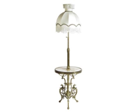 A gilt brass standard lamp, with an adjustable stem above an onyx shelf on griffin monopodia supports, with shade, 191.7cm hi