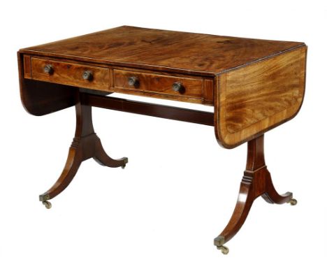 A late George III mahogany sofa table, inlaid with stringing, the drop-leaf top with satinwood and palmwood crossbanding, abo