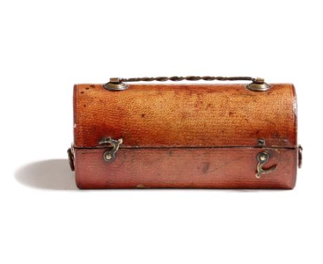 A George III red Morocco leather travelling inkwell, in the form of a trunk with copper handles, the hinged domed lid reveali