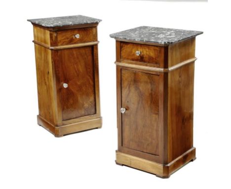 A near pair of French walnut bedside cupboards, each with a grey marble top, above a frieze drawer and a door enclosing a she